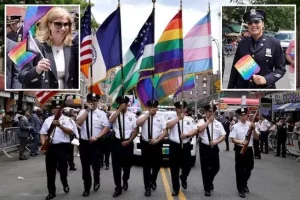 NYC police marching in the 2011 gay pride parade carrying city, police departmetn, and gay flags 